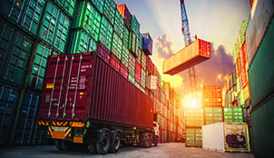 Lorry carrying container at dock yard